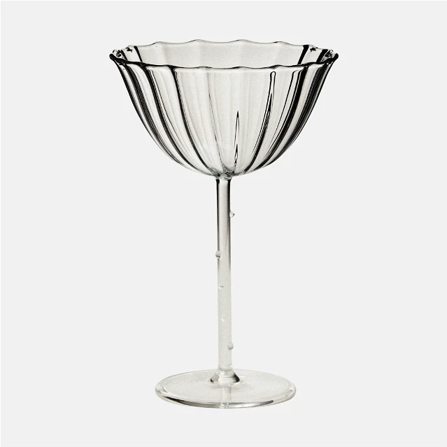 a wine glass sitting on top of a table