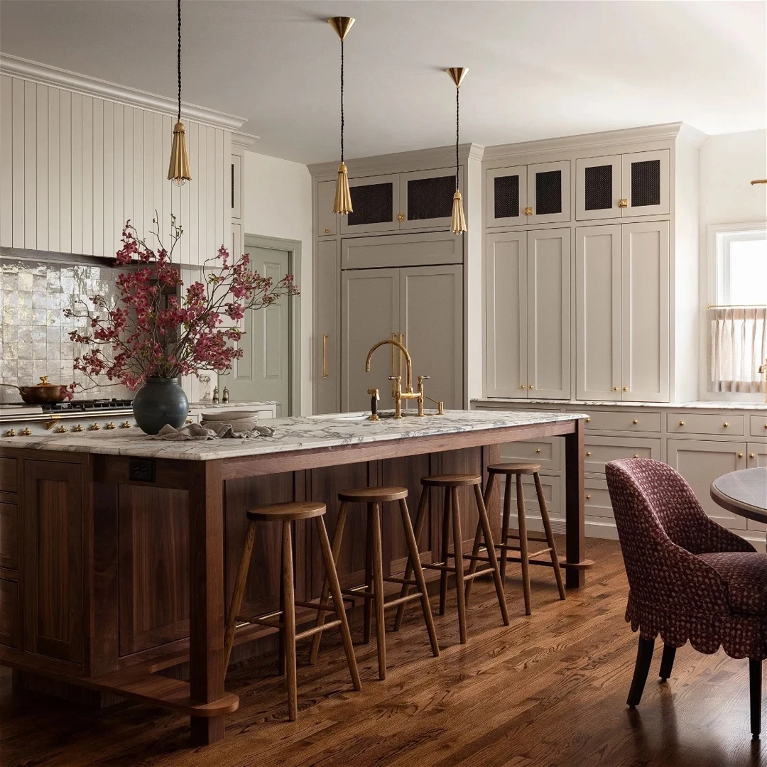 a large kitchen with a center island and bar stools